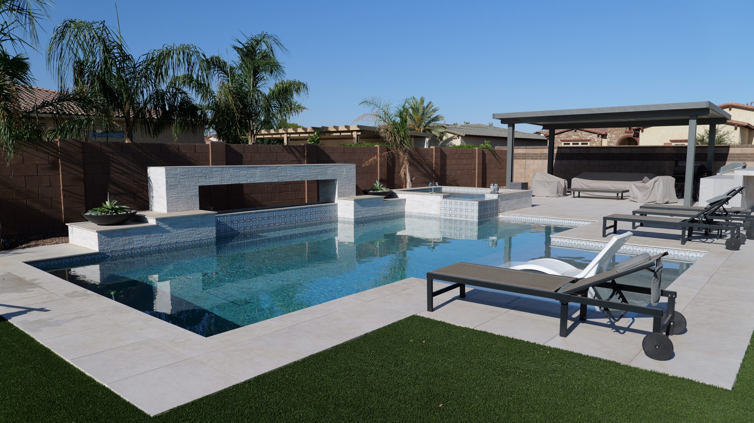 Remodeled backyard swimming pool by Pelican Pools